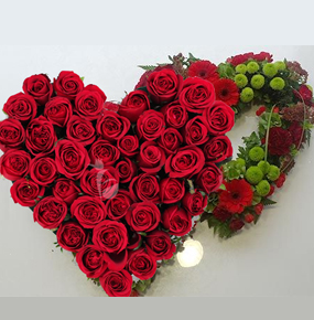 Double entwined heart of red roses and gerbera